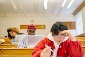 Students sitting in lectures using laptops